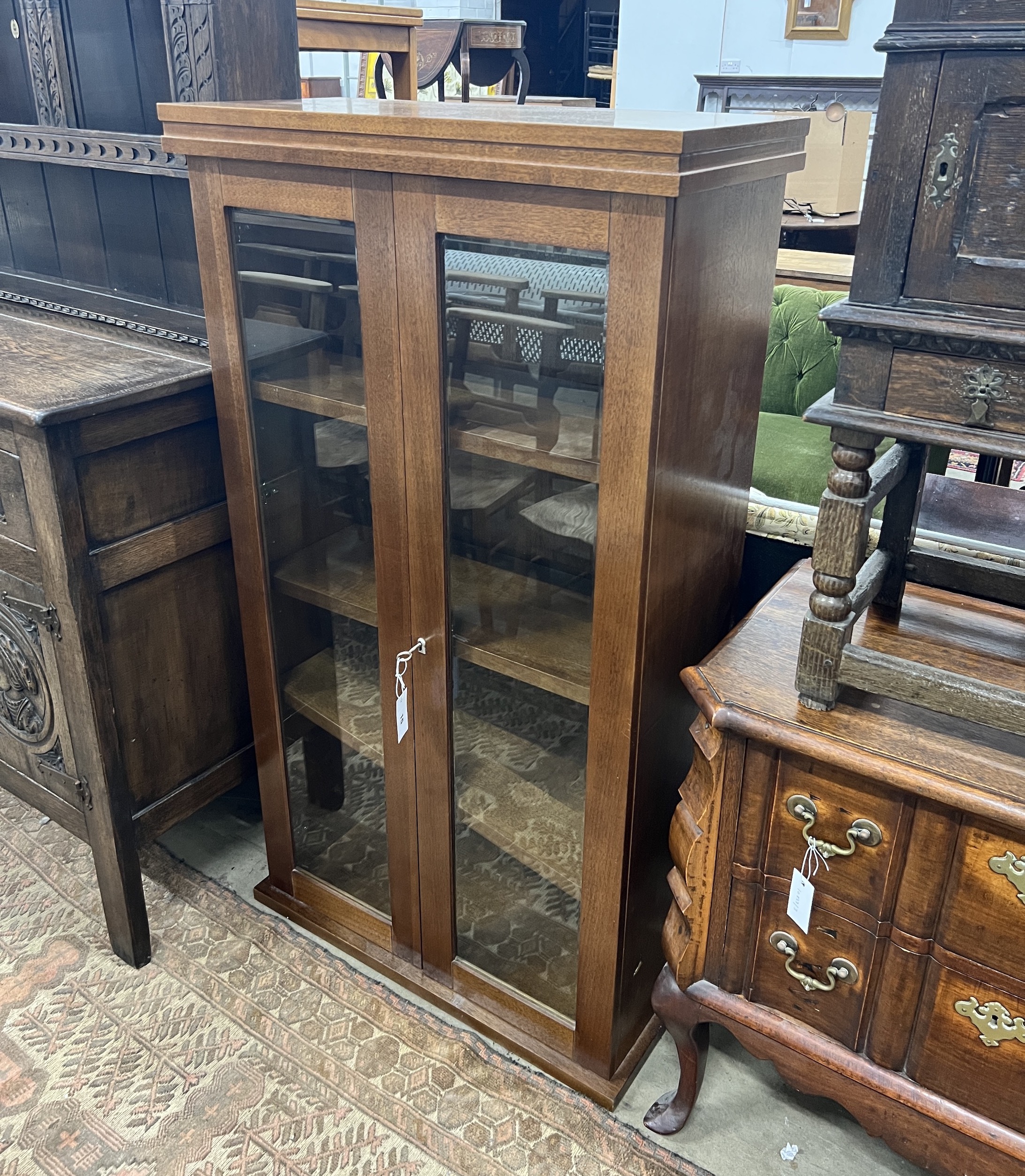 A South African mahogany glazed two door bookcase, width 75cm, depth 35cm, height 135cm